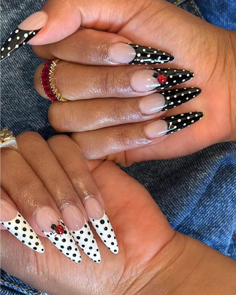 Black and white polka dot french tip nails with lady bugs.